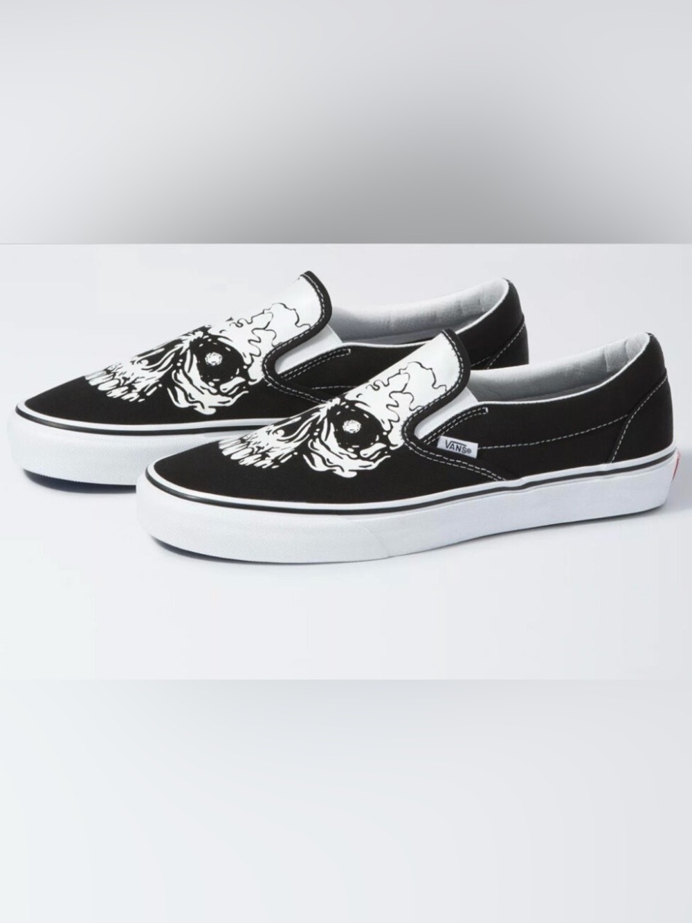 Vans Kids Slip-On Sneakers in Black and White Skull Graphic